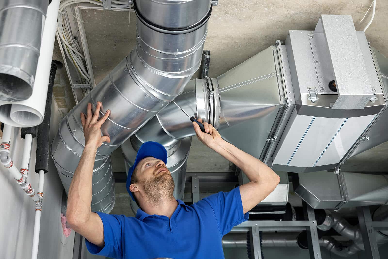 HVAC technician inspecting and repairing air ducts in Santa Barbara